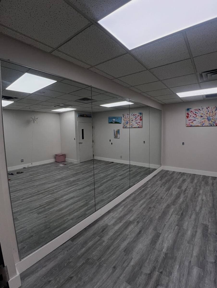 Wall-to-wall studio mirror installed by Totowa Glass