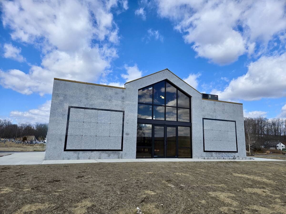 Granite building facade with custom glass entrance